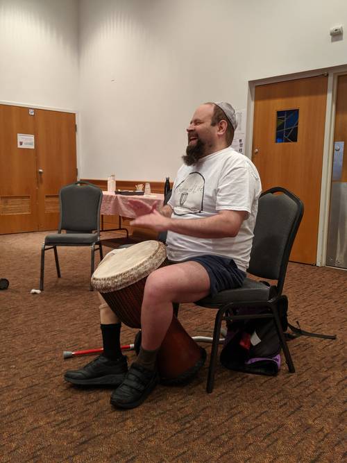 Drum Circle leader Al Fredel leading the group in a tune